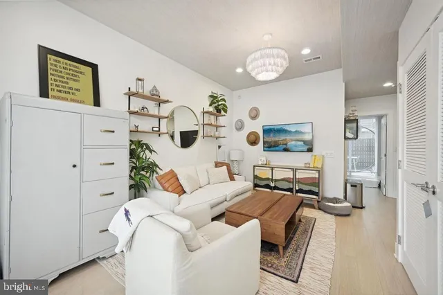 a living room with furniture and a chandelier