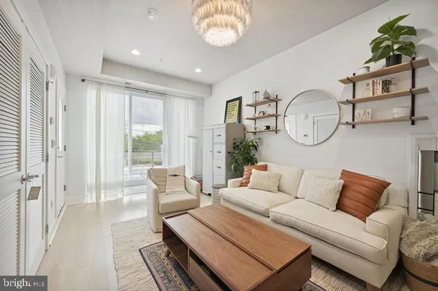 a living room with furniture a rug and a window