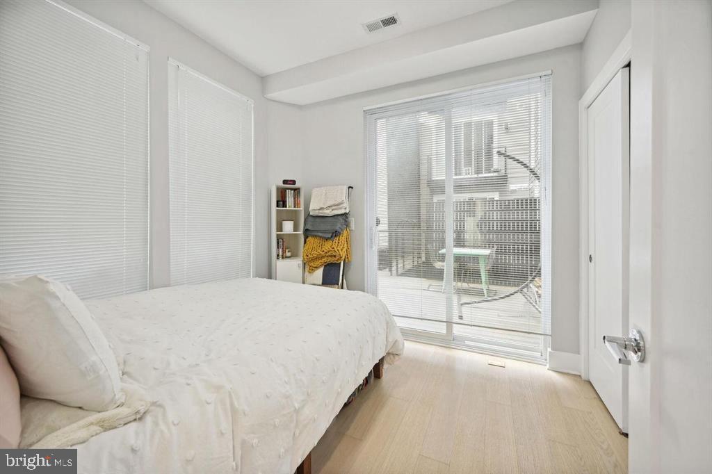 4016 Georgia Avenue Northwest, Unit 4 Washington, DC 20011 - Photo 7 of 13 a bedroom with a bed and a window