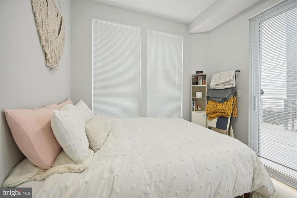 4016 Georgia Avenue Northwest, Unit 4 Washington, DC 20011 - Photo 8 of 13 a bedroom with a bed and wooden floor