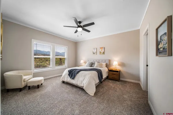 a spacious bedroom with a bed and a window