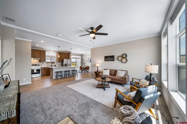 a living room with furniture and kitchen view
