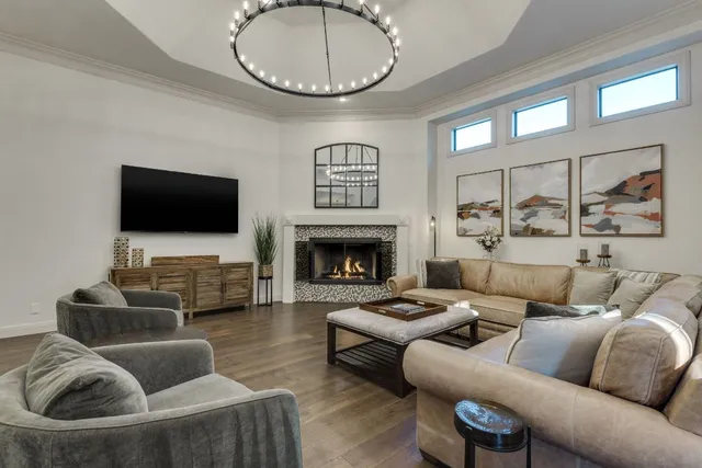 a living room with furniture a flat screen tv and a fireplace