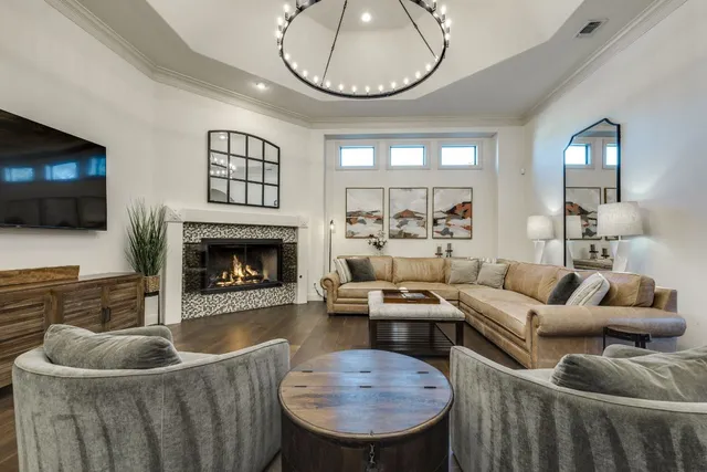 a view of a dining room with furniture a chandelier and wooden floor