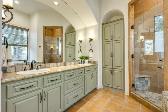 a bathroom with a tub a sink and a shower