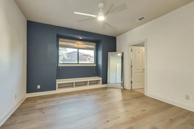 a bedroom with a large bed and a window