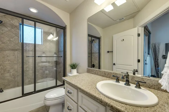 a kitchen with granite countertop a stove and a sink