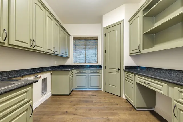 a stove top oven sitting inside of a kitchen