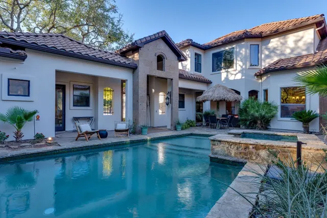 swimming pool view with a seating space
