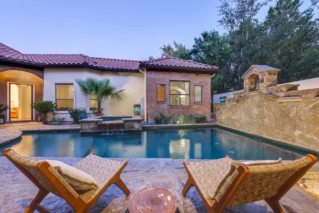 a view of a swimming pool with outdoor seating