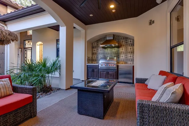 a kitchen with granite countertop a stove and a wooden cabinets