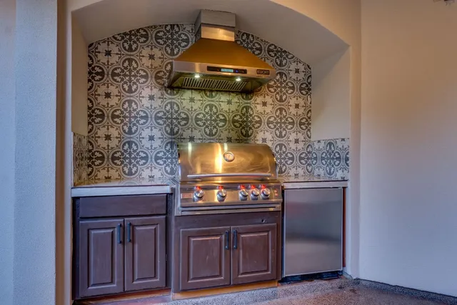 a front view of a house with a yard and tree s