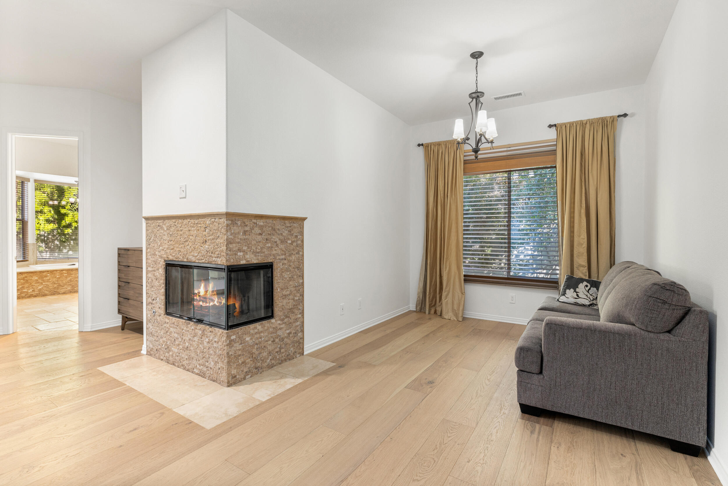 8 Trafalgar Rancho Mirage, CA 92270 - Photo 15 of 41 a living room with furniture and a fireplace