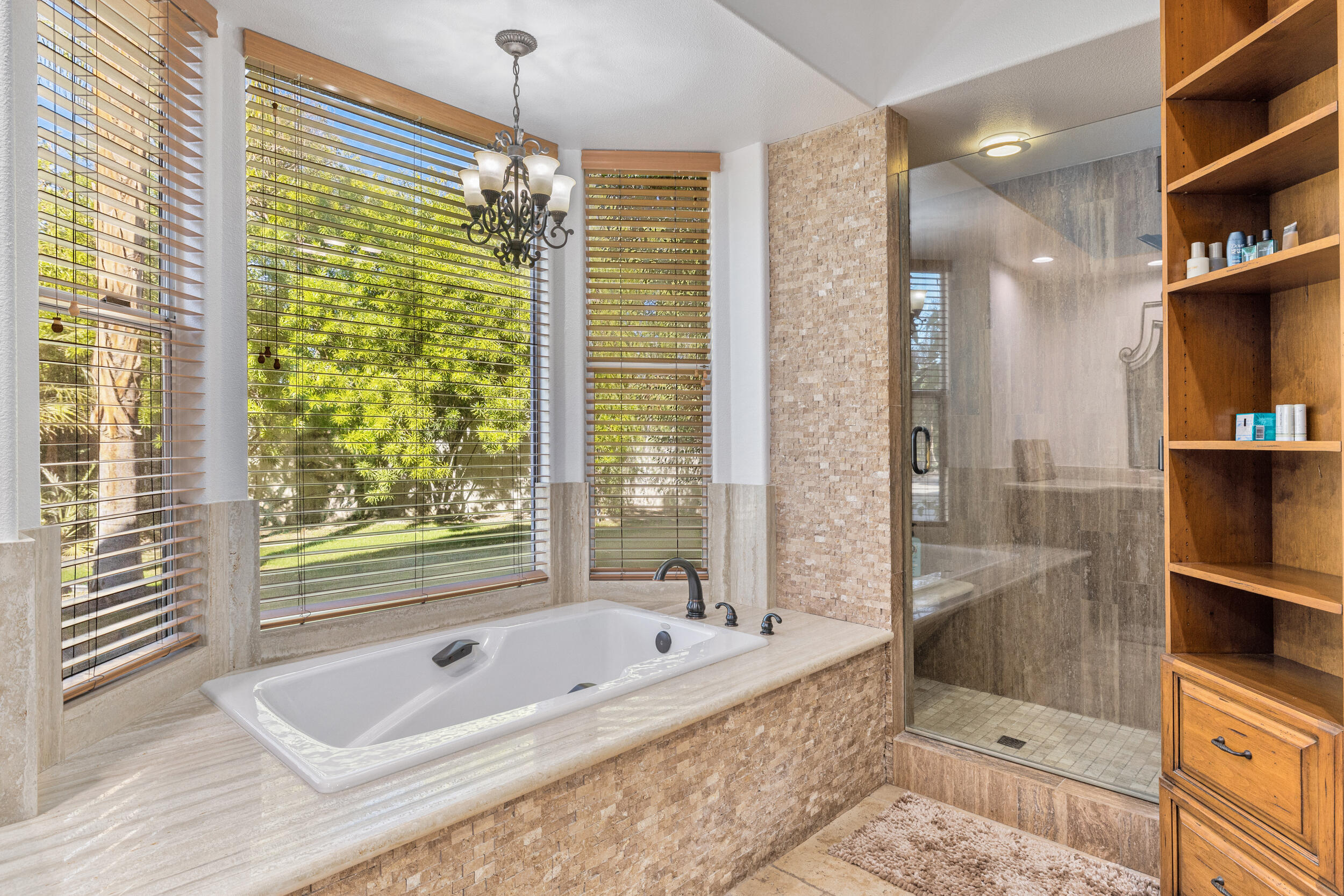 8 Trafalgar Rancho Mirage, CA 92270 - Photo 17 of 41 a bathroom with a tub a window and a shower