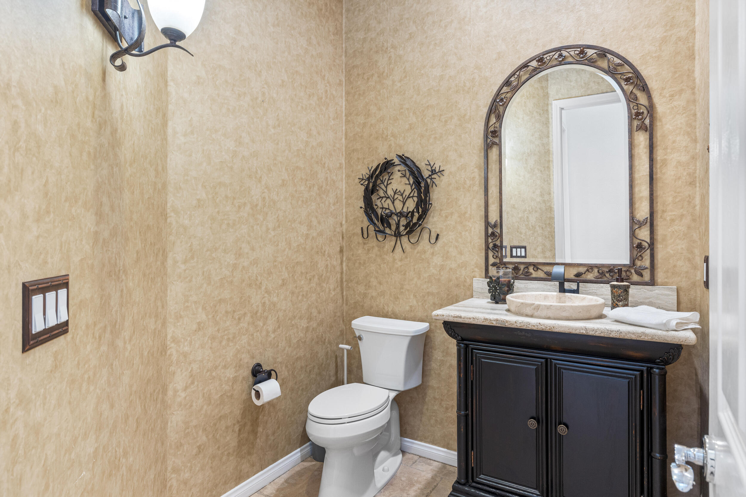 8 Trafalgar Rancho Mirage, CA 92270 - Photo 19 of 41 a bathroom with a toilet sink and mirror