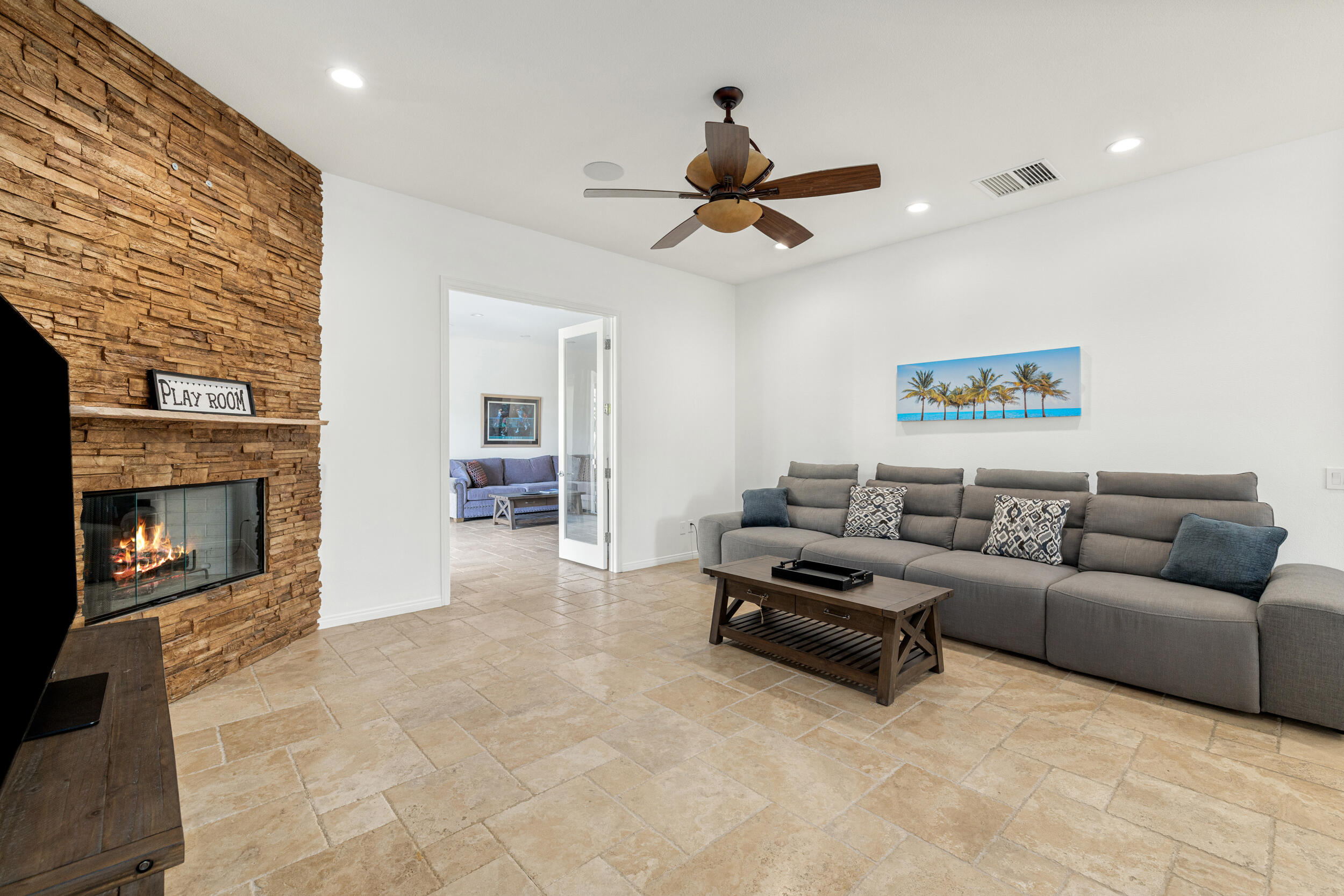 8 Trafalgar Rancho Mirage, CA 92270 - Photo 26 of 41 a living room with furniture and a fireplace