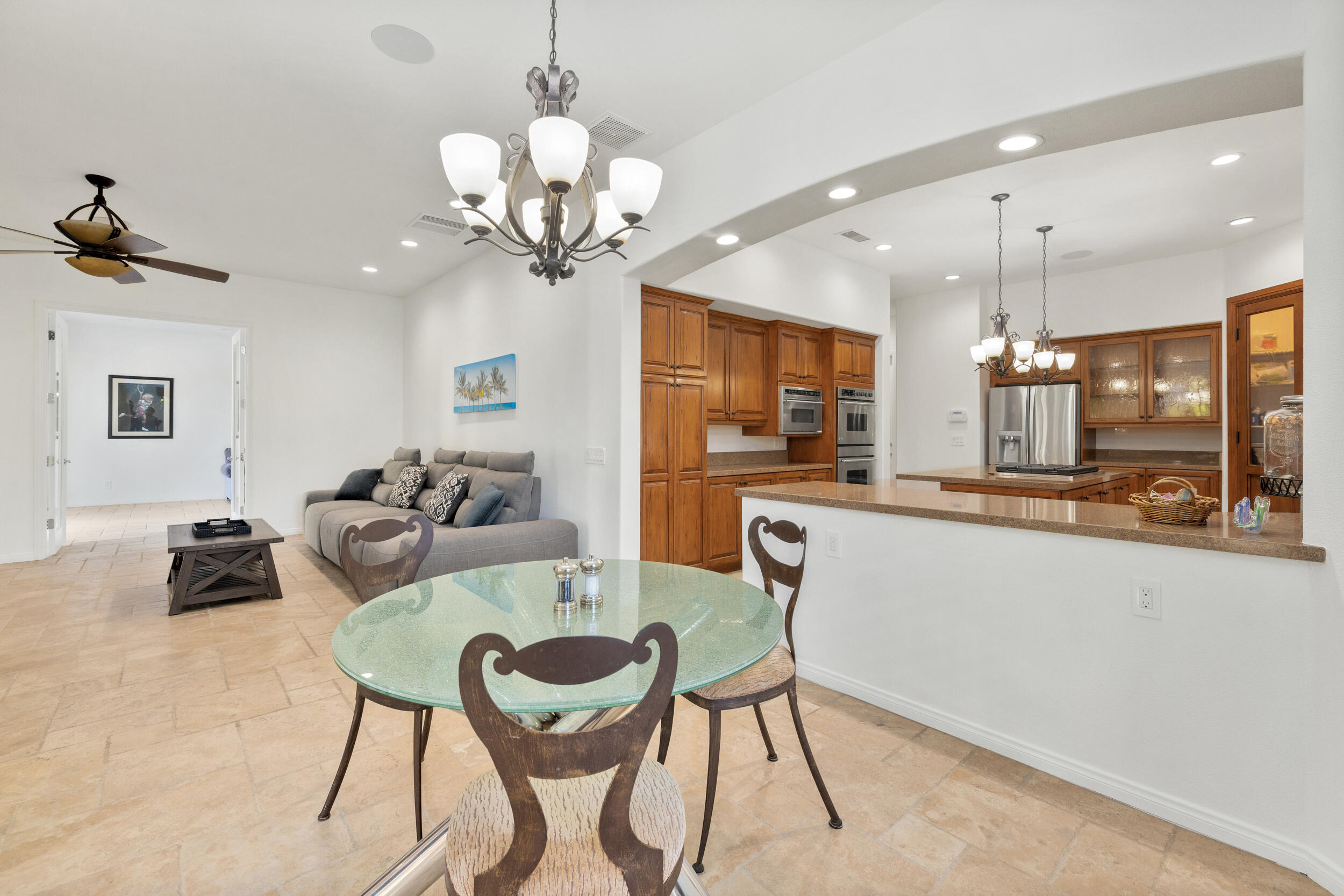 8 Trafalgar Rancho Mirage, CA 92270 - Photo 27 of 41 a living room with kitchen island furniture and a chandelier