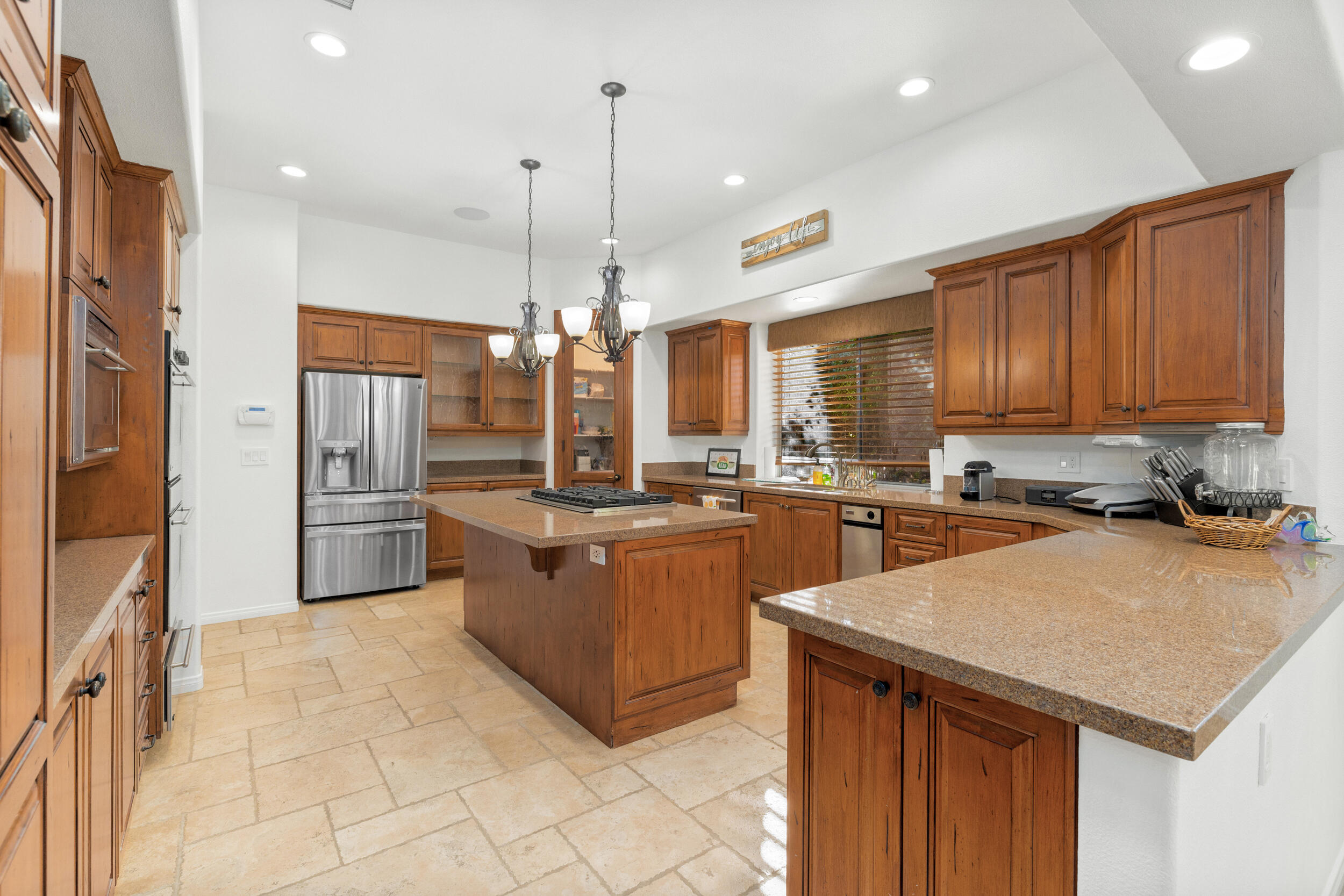 8 Trafalgar Rancho Mirage, CA 92270 - Photo 28 of 41 a kitchen with stainless steel appliances granite countertop a sink a stove and a refrigerator