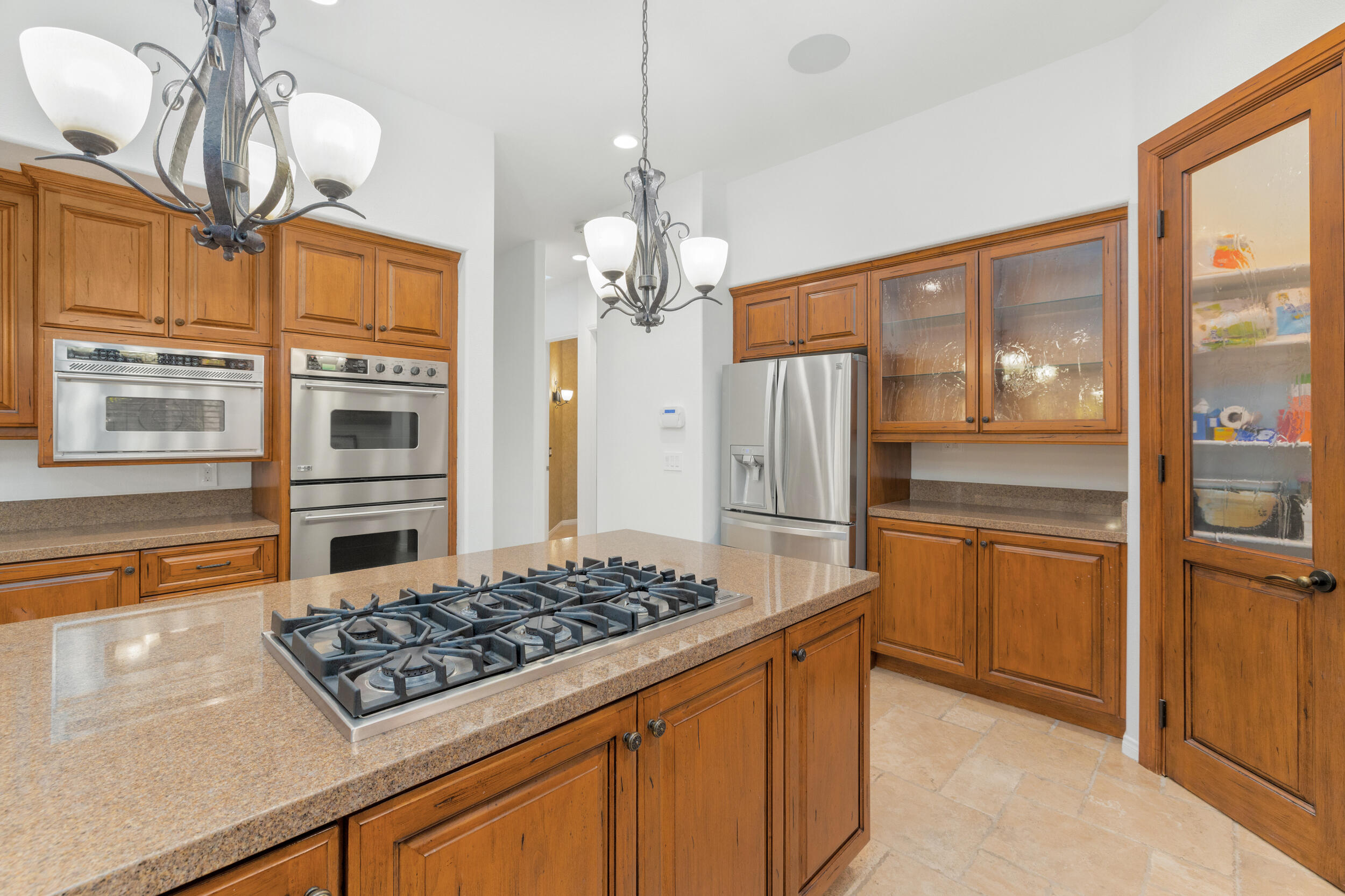 8 Trafalgar Rancho Mirage, CA 92270 - Photo 30 of 41 a kitchen with stainless steel appliances granite countertop a stove and a refrigerator