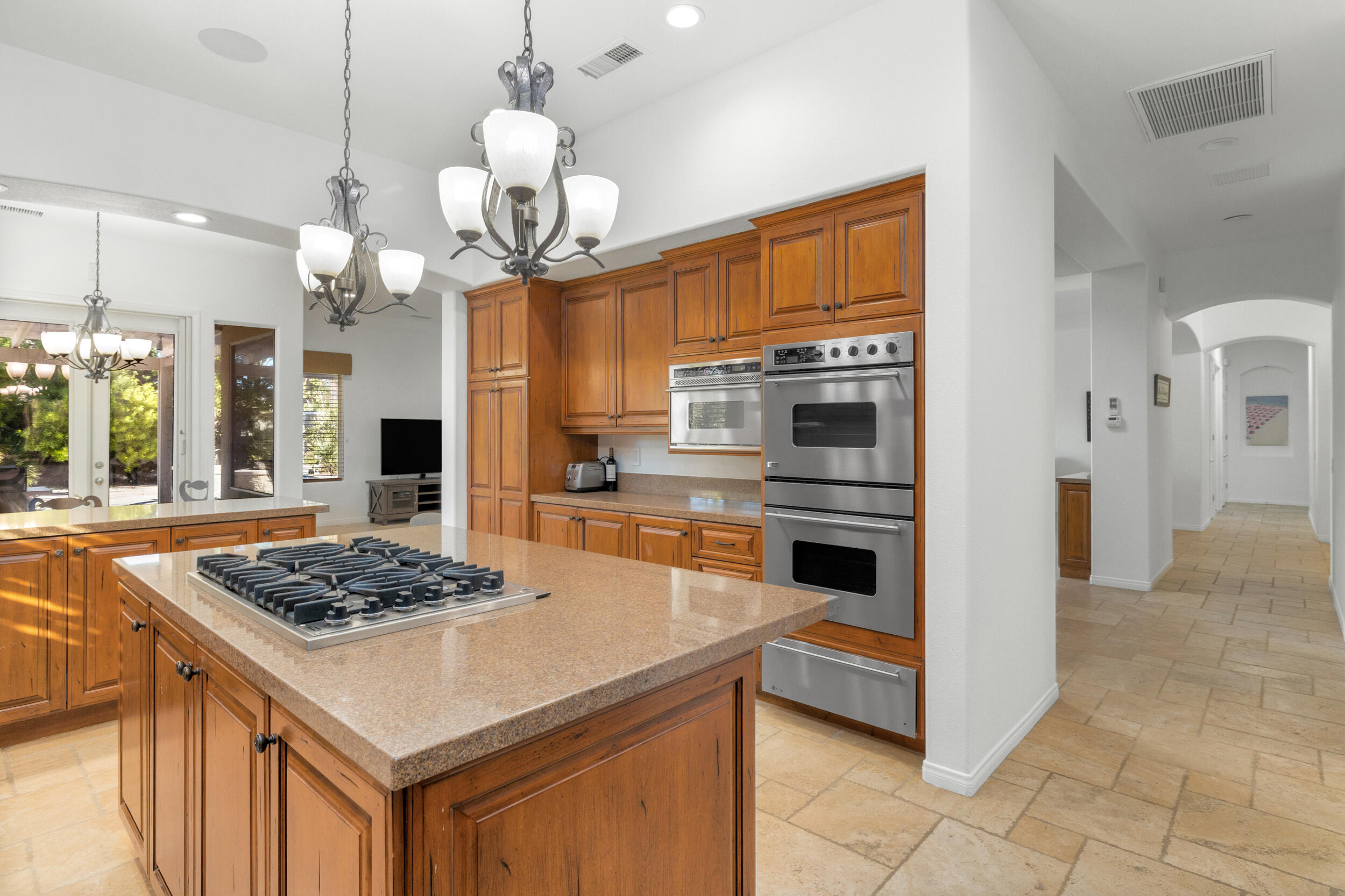 8 Trafalgar Rancho Mirage, CA 92270 - Photo 31 of 41 a kitchen with a refrigerator a stove a sink and a refrigerator