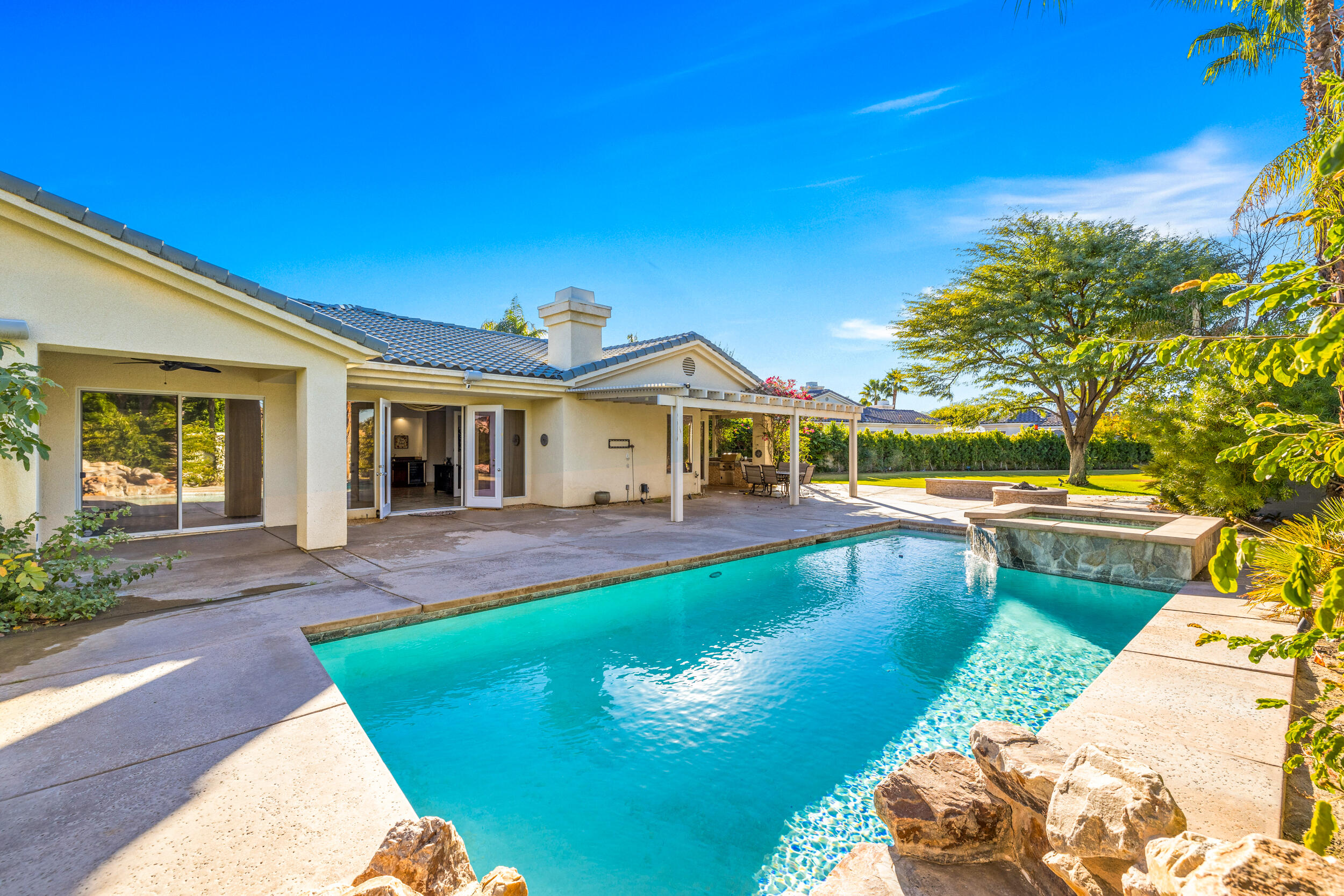 8 Trafalgar Rancho Mirage, CA 92270 - Photo 33 of 41 a view of a house with swimming pool and a yard