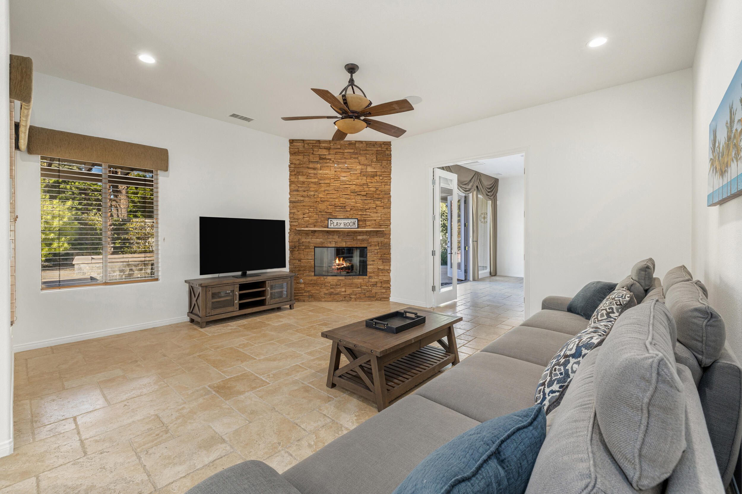 8 Trafalgar Rancho Mirage, CA 92270 - Photo 6 of 41 a living room with furniture a flat screen tv and a large window