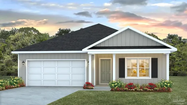 a front view of a house with a garden and garage