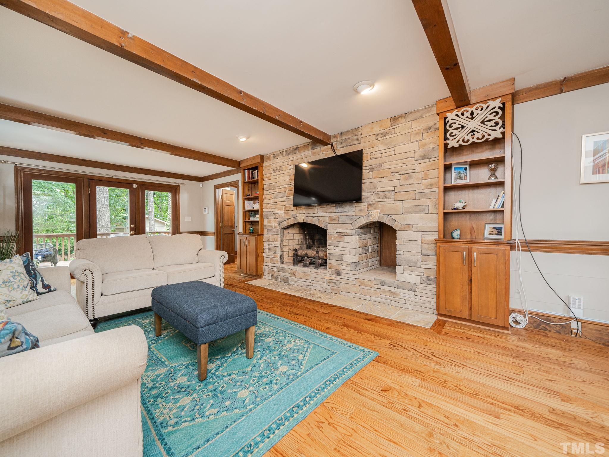 5029 Trail Ridge Drive Raleigh, NC 27613 - Photo 12 of 37 a living room with furniture a flat screen tv and a fireplace