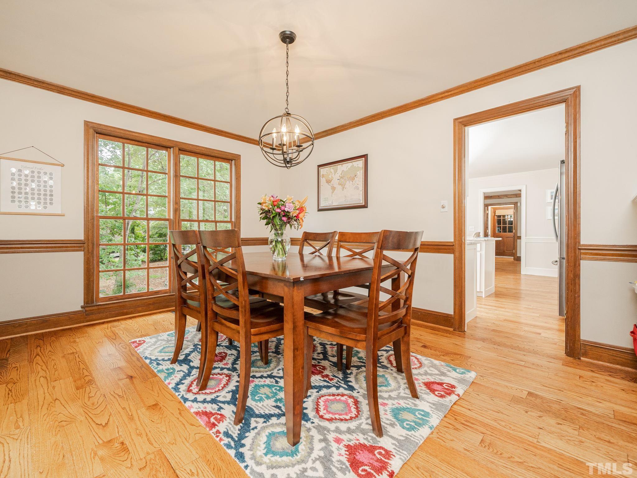 5029 Trail Ridge Drive Raleigh, NC 27613 - Photo 13 of 37 a view of a dining room with furniture wooden floor and chandelier
