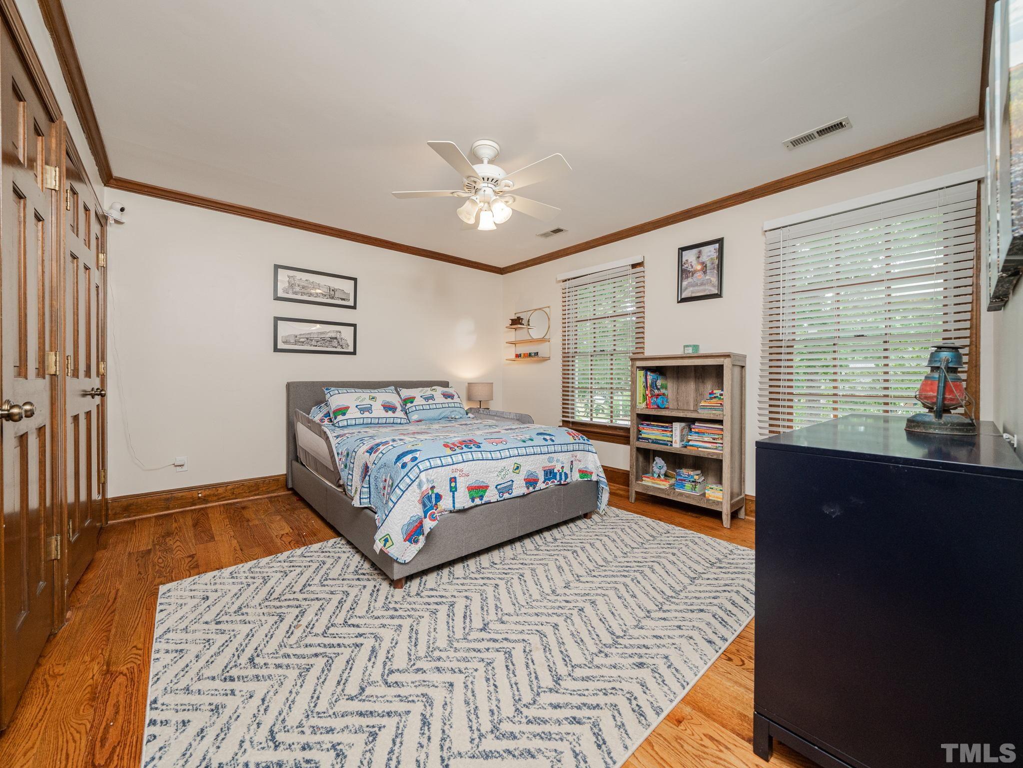 5029 Trail Ridge Drive Raleigh, NC 27613 - Photo 18 of 37 a bedroom with a large bed and a window