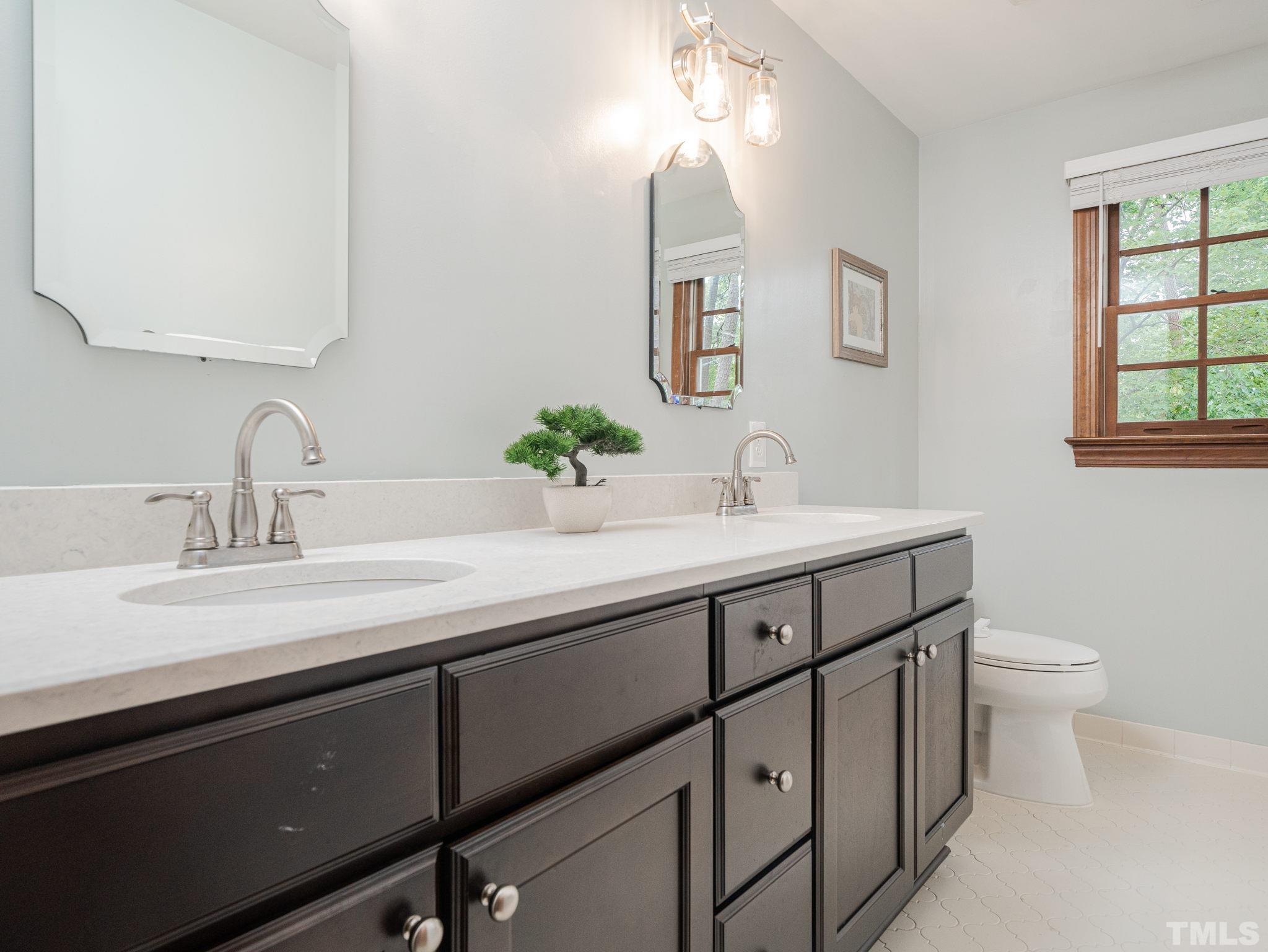 5029 Trail Ridge Drive Raleigh, NC 27613 - Photo 19 of 37 a bathroom with a sink and a toilet