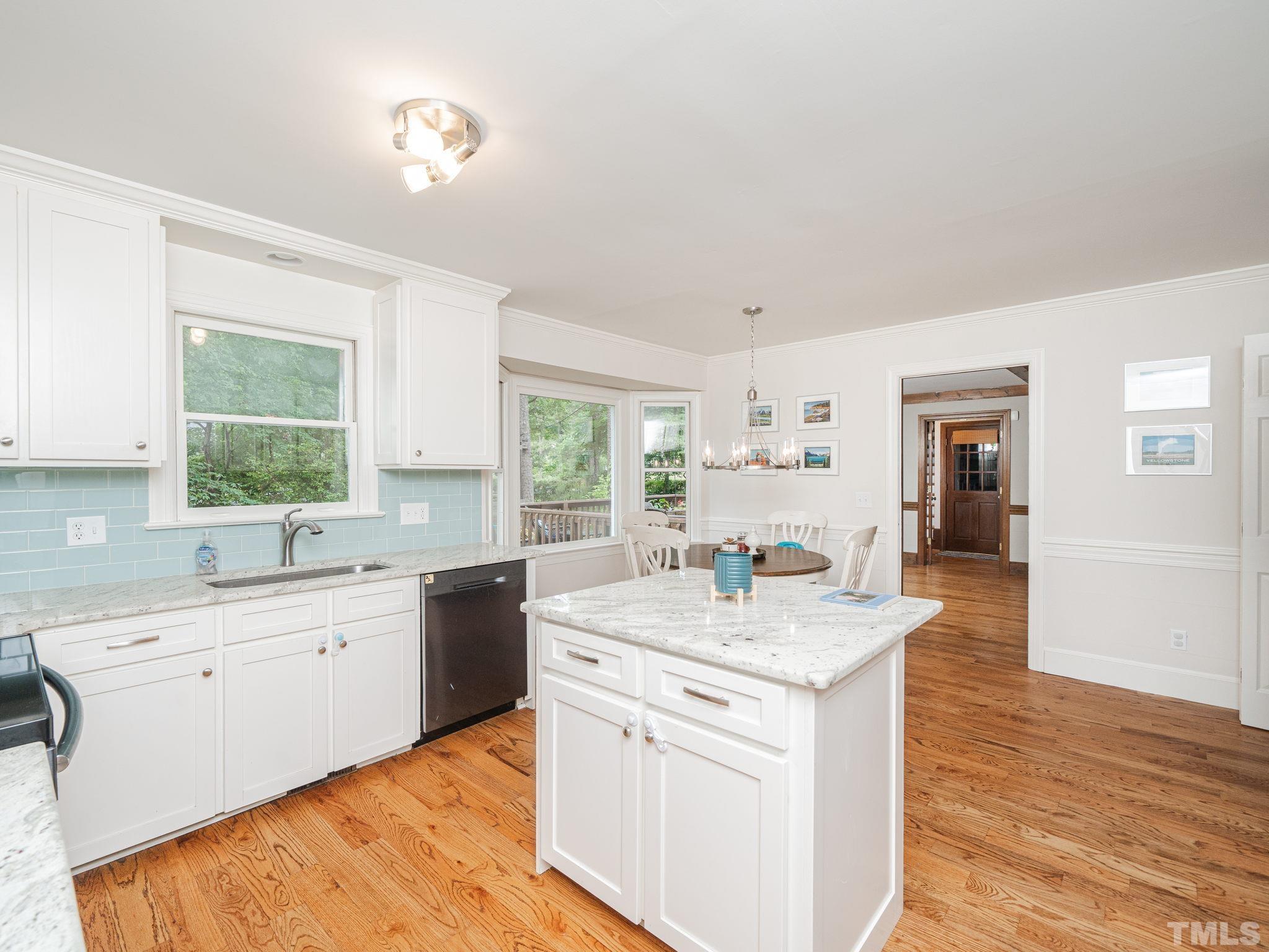 5029 Trail Ridge Drive Raleigh, NC 27613 - Photo 2 of 37 a kitchen with a sink cabinets appliances and a window
