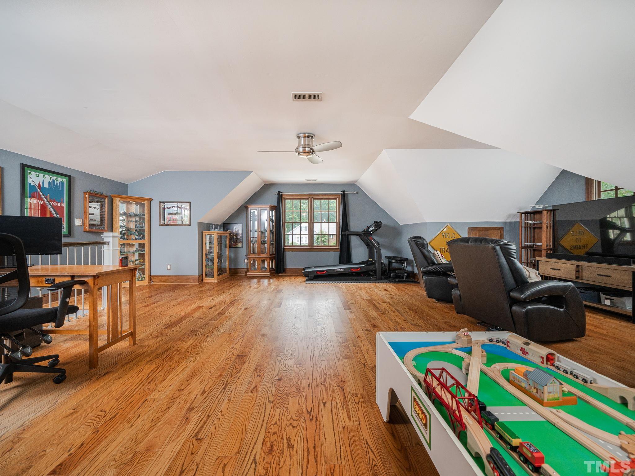 5029 Trail Ridge Drive Raleigh, NC 27613 - Photo 21 of 37 a bed room with furniture and a flat screen tv