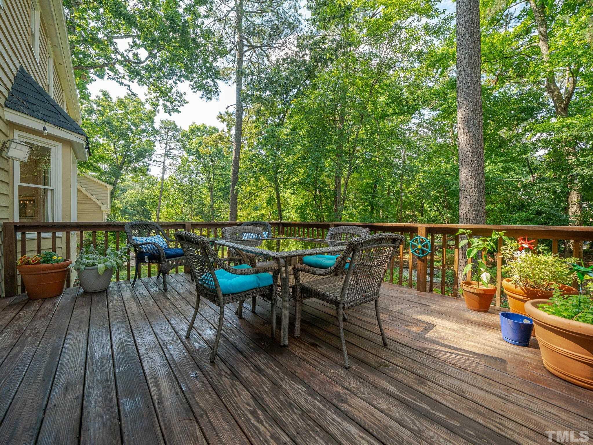 5029 Trail Ridge Drive Raleigh, NC 27613 - Photo 27 of 37 a view of a deck with table and chairs wooden floor and fence