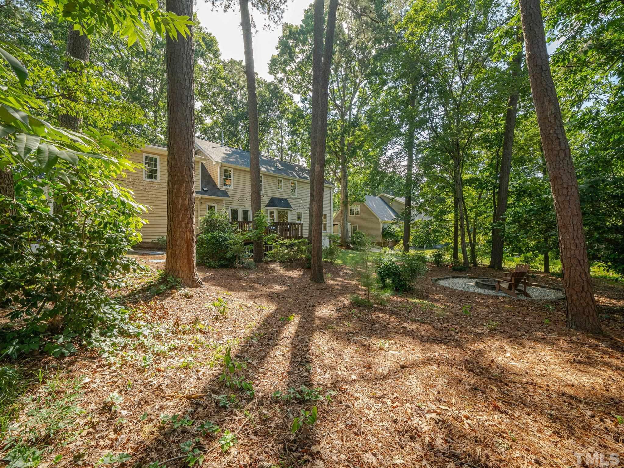 5029 Trail Ridge Drive Raleigh, NC 27613 - Photo 30 of 37 a view of a tree in the middle of a yard