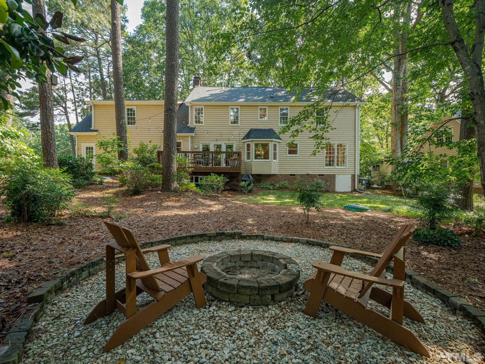 5029 Trail Ridge Drive Raleigh, NC 27613 - Photo 31 of 37 a view of a chairs and table in the backyard