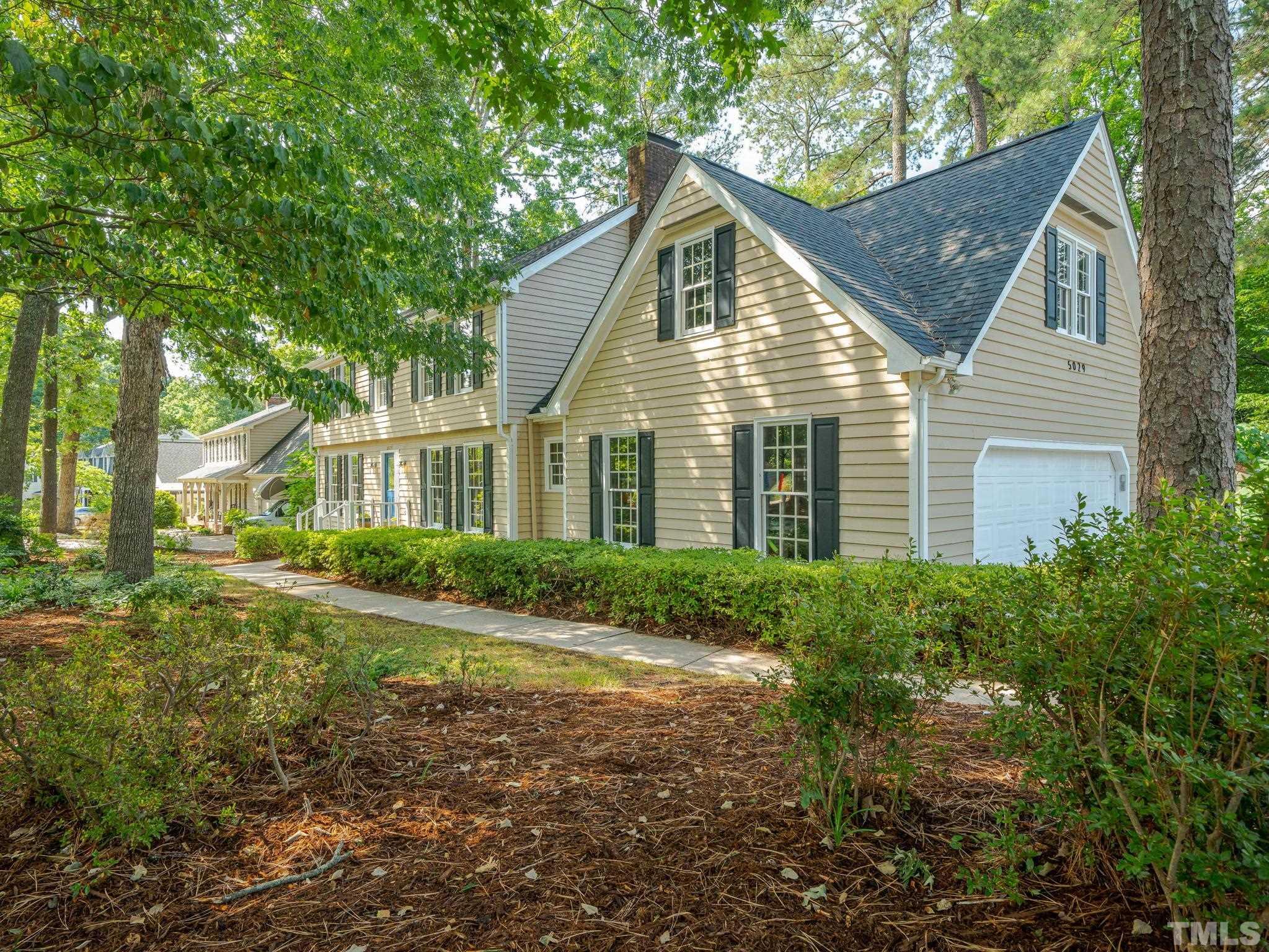 5029 Trail Ridge Drive Raleigh, NC 27613 - Photo 36 of 37 a view of a yard in front of a house with large windows