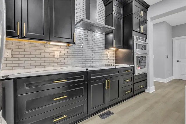 a kitchen with granite countertop cabinets stainless steel appliances and a sink