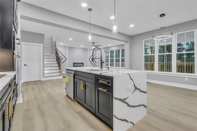a kitchen with stainless steel appliances granite countertop a stove and a sink