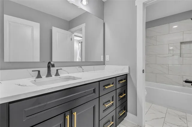 a bathroom with a sink double vanity and a bathtub