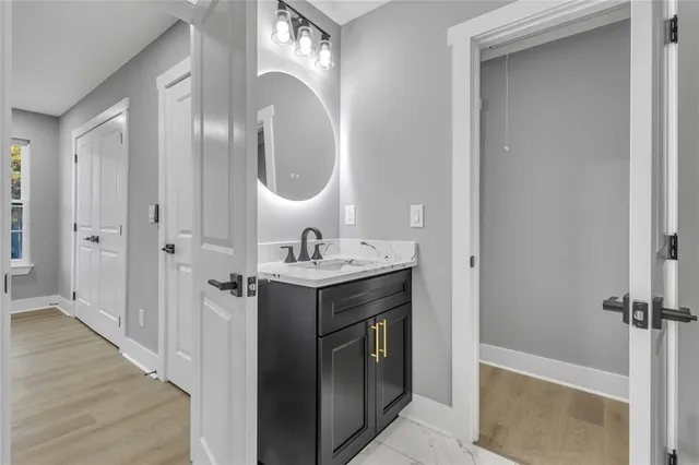 a bathroom with a sink a mirror and a shower