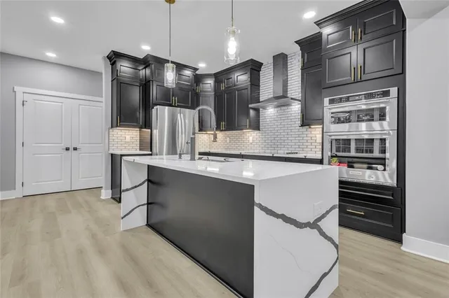 a kitchen with refrigerator and cabinets