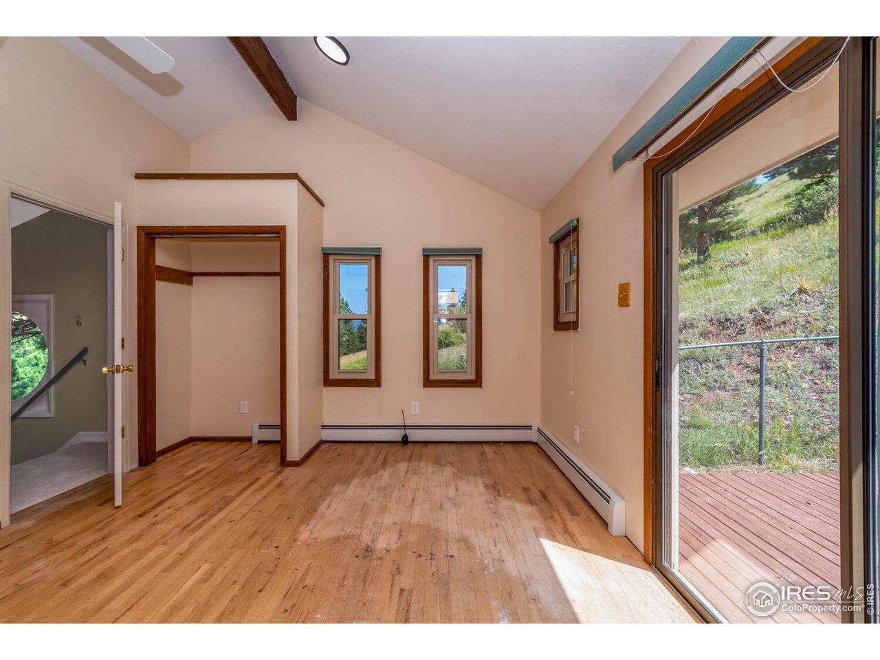 6778 Olde Stage Road Boulder, CO 80302 - Photo 24 of 40 Upper secondary bedroom is vaulted and has hardwood floor and private deck