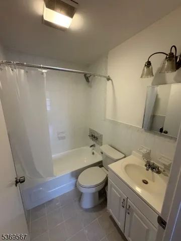 a bathroom with a sink a toilet and a shower