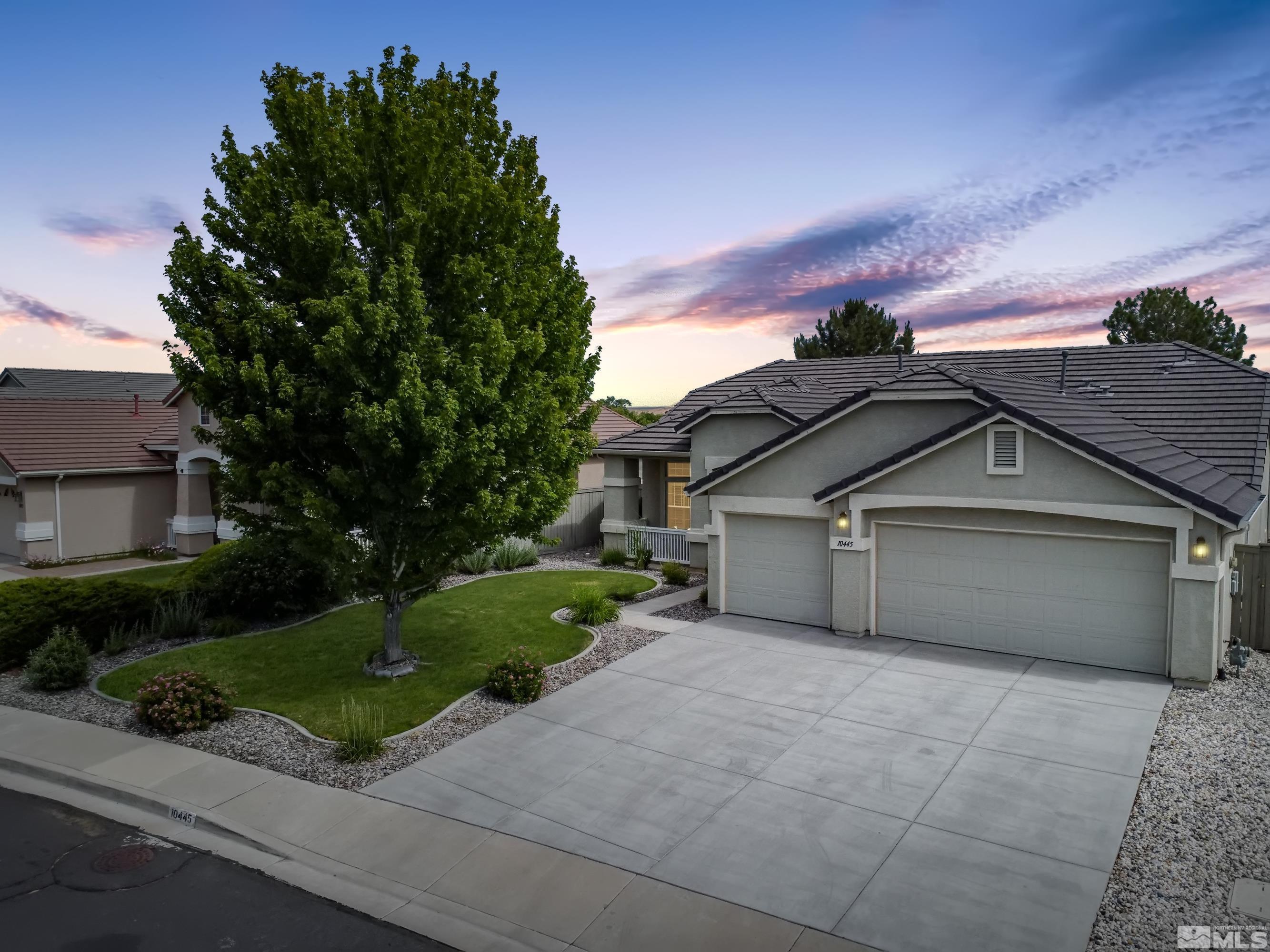 10445 Arbor Way Reno, NV 89521 - Photo 1 of 39 a front view of a house with a garden and trees