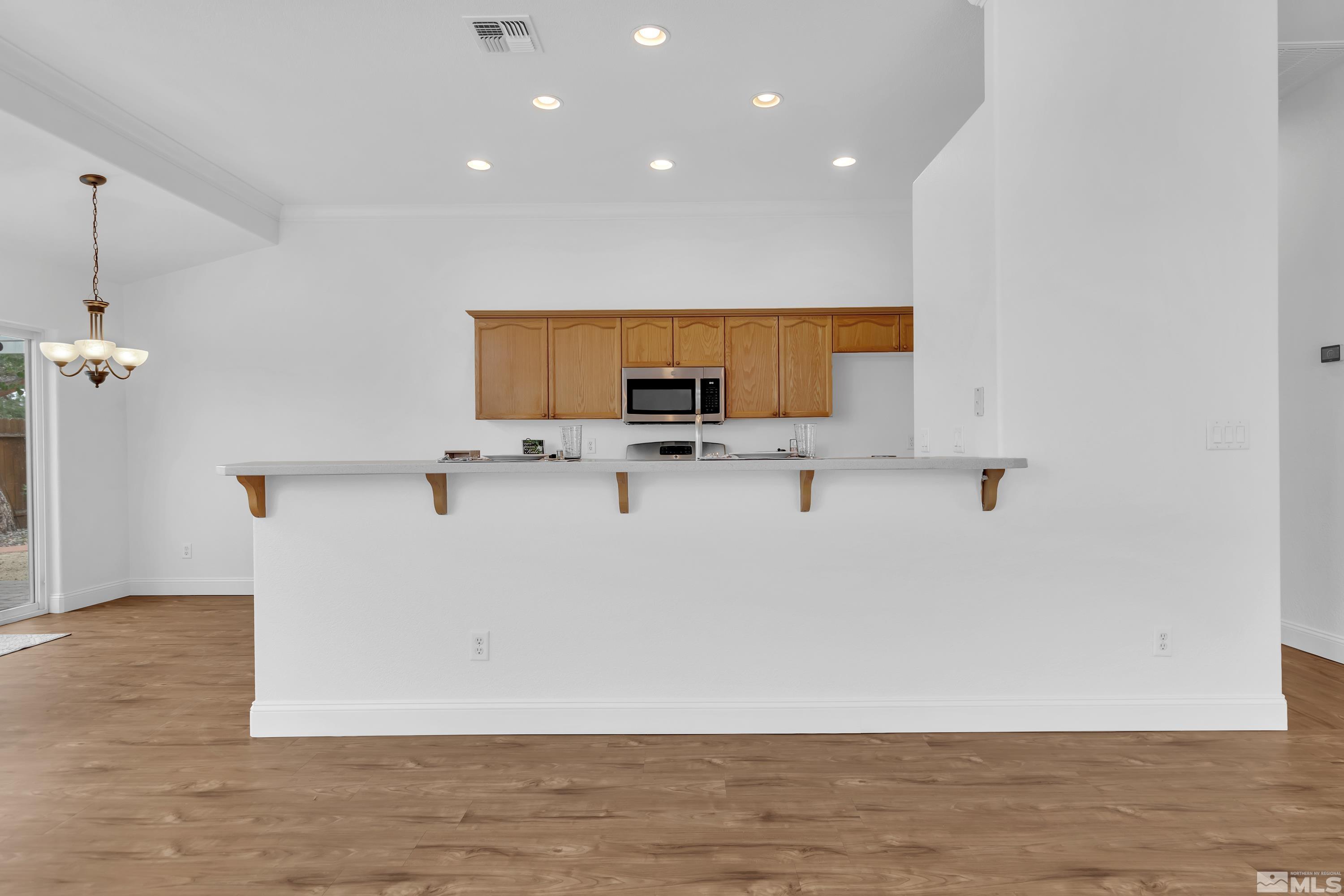 10445 Arbor Way Reno, NV 89521 - Photo 13 of 39 a view of kitchen with stainless steel appliances granite countertop a stove a sink and a microwave