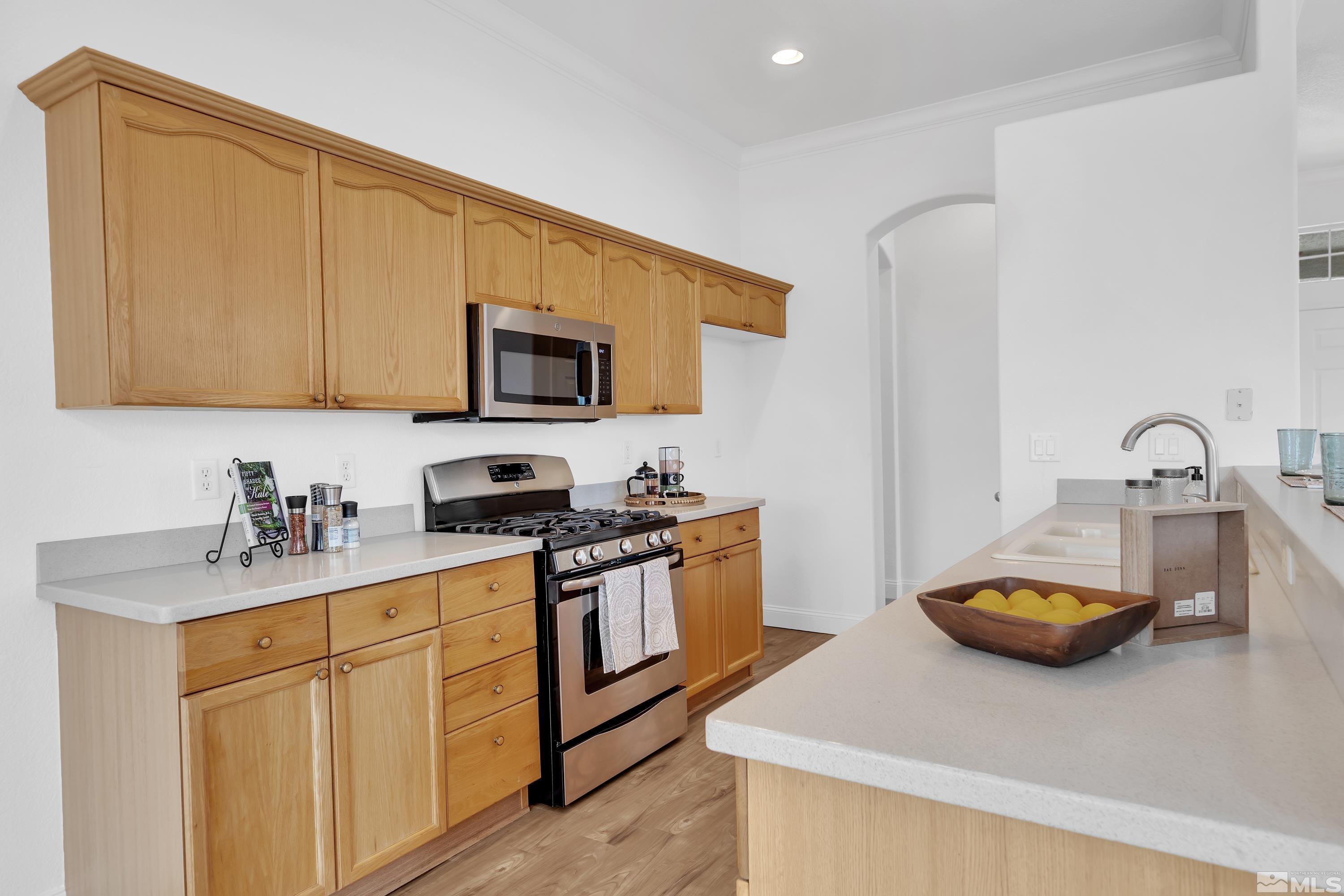 10445 Arbor Way Reno, NV 89521 - Photo 17 of 39 a kitchen with a sink a stove and cabinets