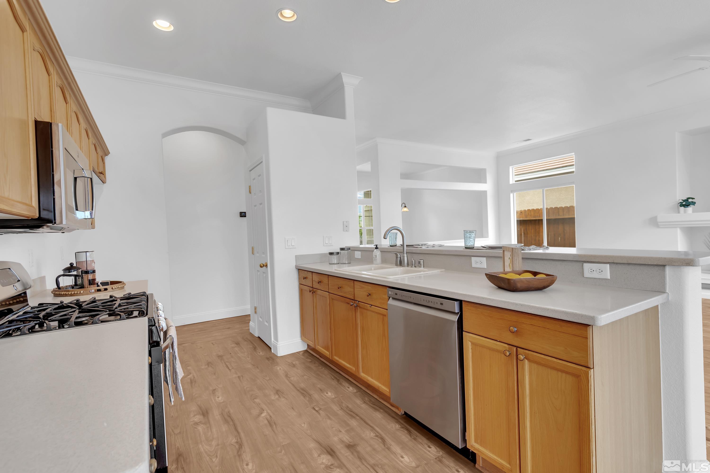 10445 Arbor Way Reno, NV 89521 - Photo 18 of 39 a kitchen with stainless steel appliances a sink stove and cabinets