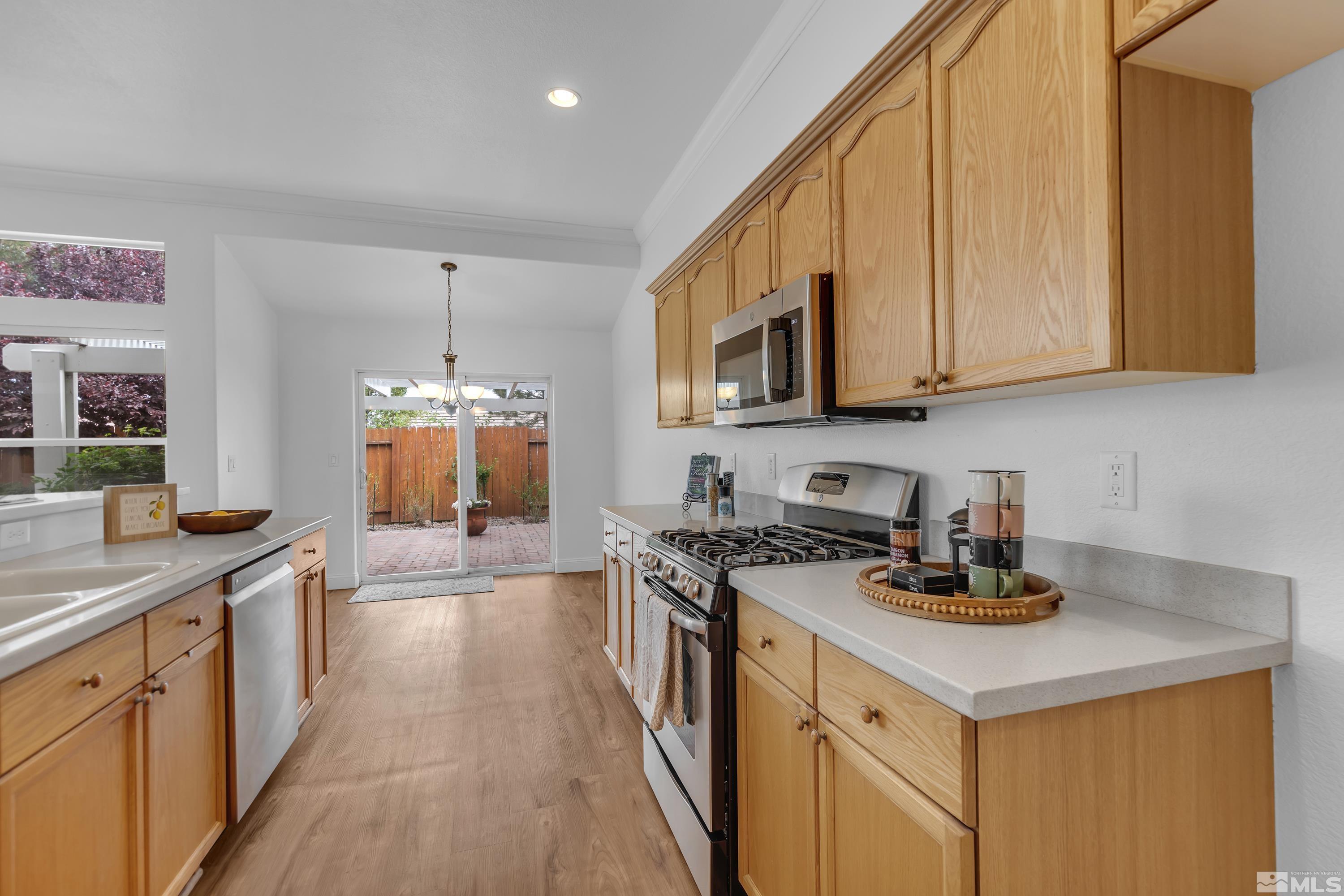 10445 Arbor Way Reno, NV 89521 - Photo 20 of 39 a kitchen with a stove top oven a sink a counter space and cabinets