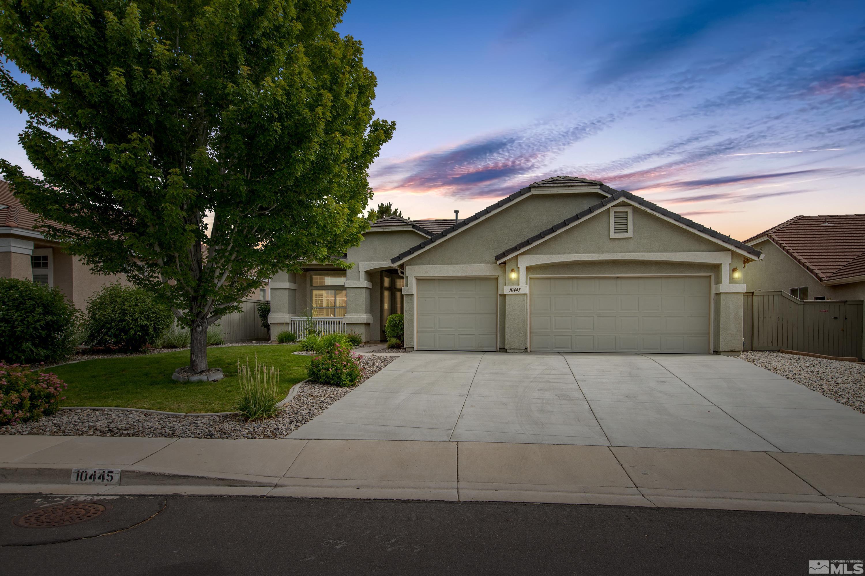 10445 Arbor Way Reno, NV 89521 - Photo 2 of 39 a front view of a house with a yard and garage